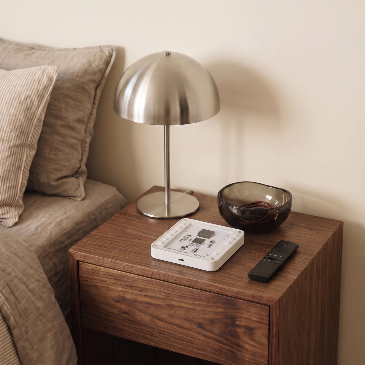 The Schumann V3 White controls on a bedside table